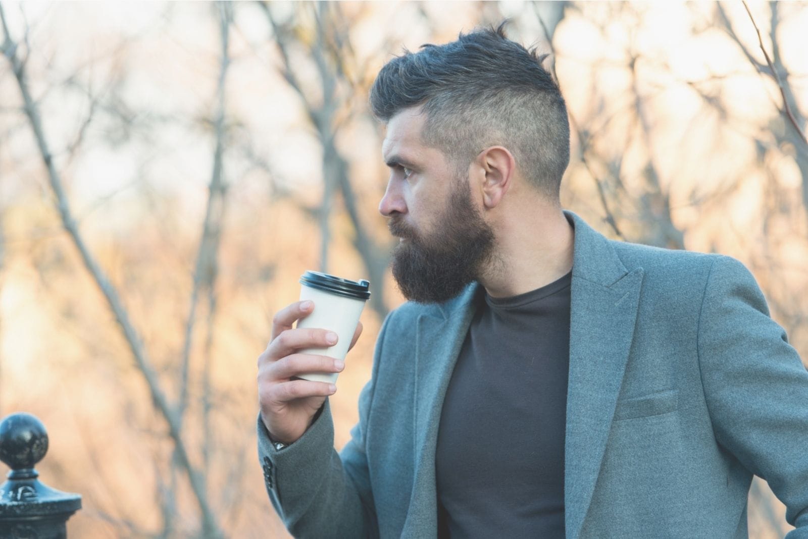 morning inspiration of a man drinking coffee outdoors thoughtful and looking away