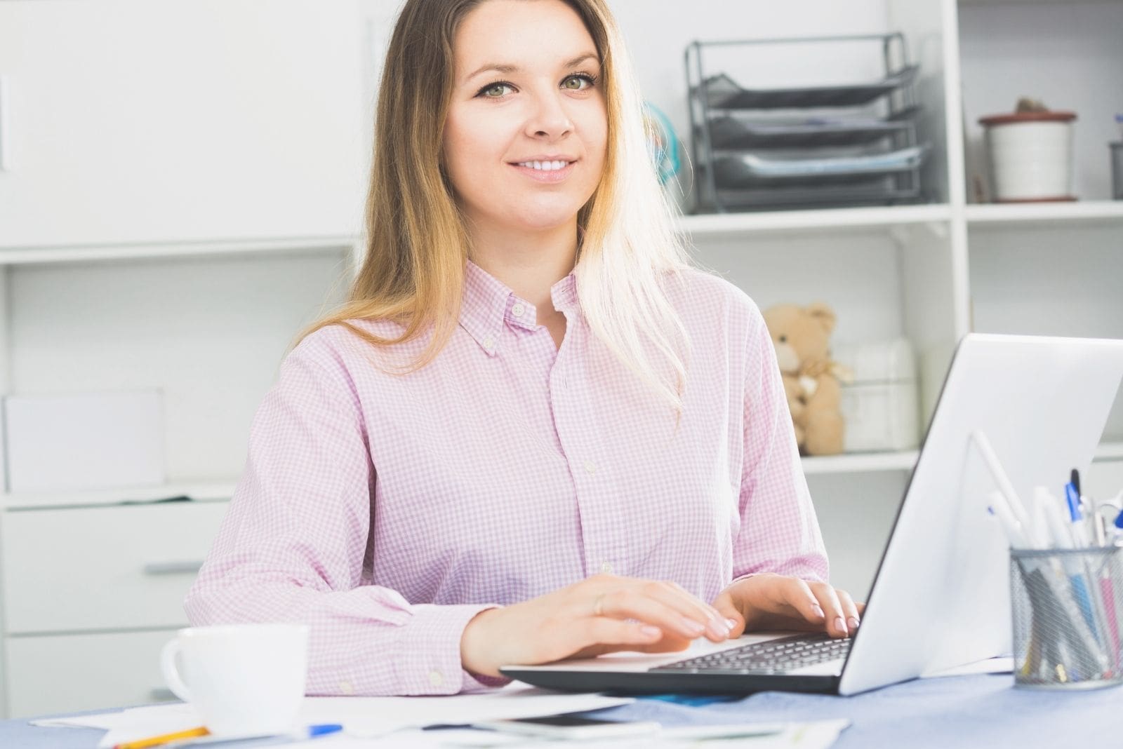 positive female worker working effectively inside the office