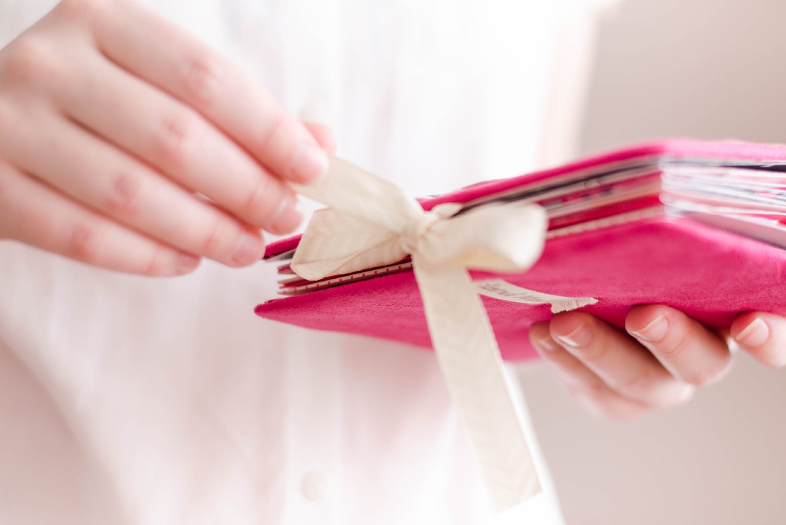 woman holding pink scrapbook album
