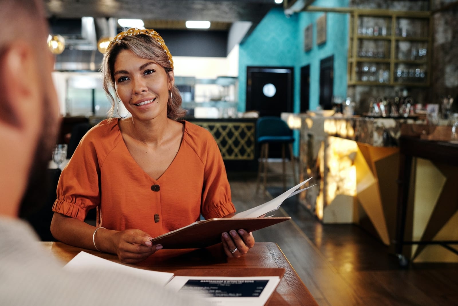 happy woman looking at man while sitting at table