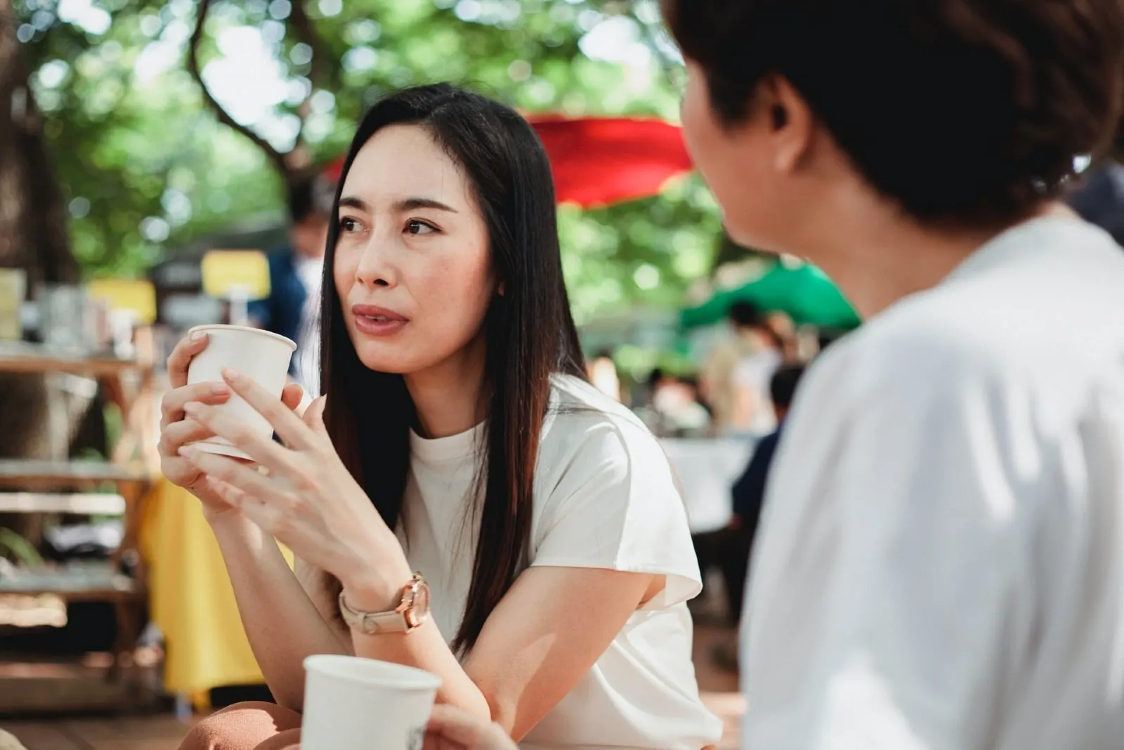woman talking to woman while having coffee