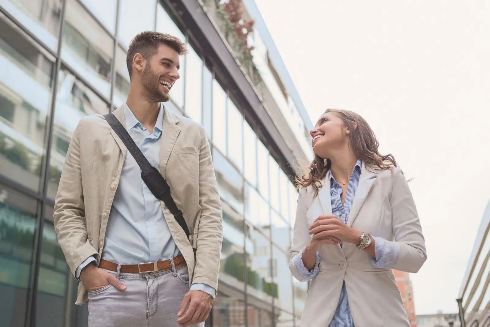 young businessman walking with a female colleague in the street outside the building