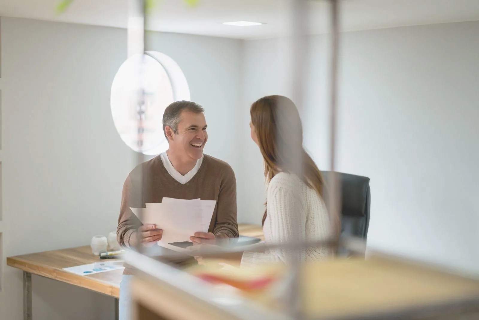 young couple worker talking inside the office laughing