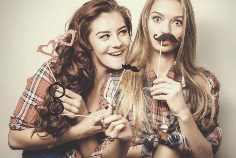 two happy female friends posing for photo