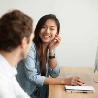 woman smiling while looking at man