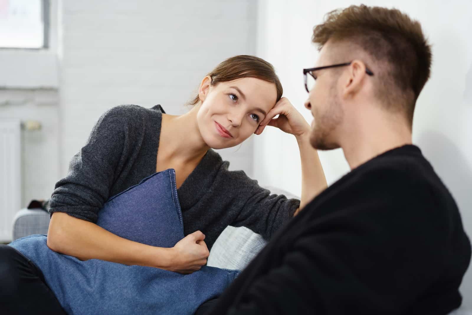 man talking to woman while sitting indoor