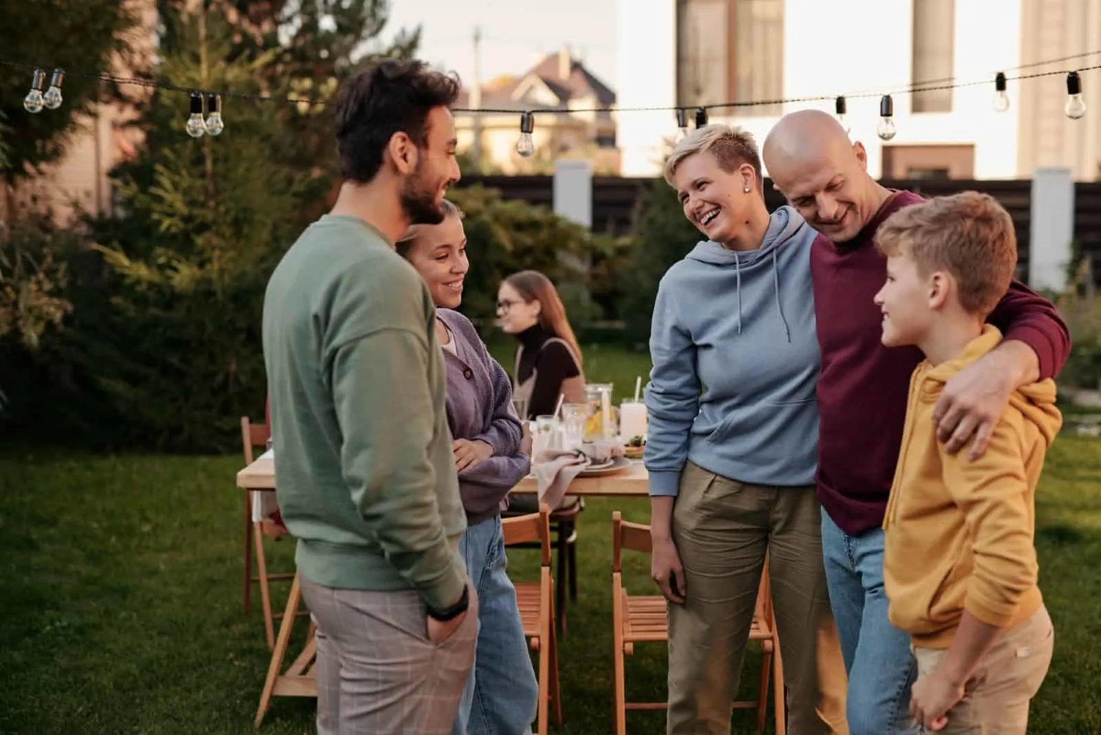 people talking while standing in backyard