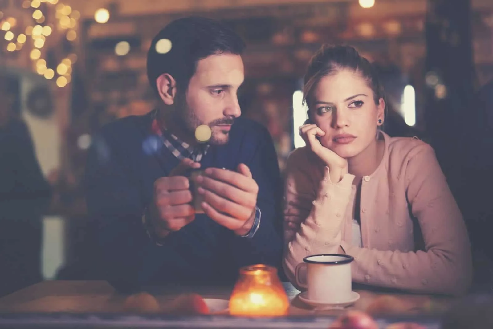 sad couple having conflict inside a restaurant while having a dinner date