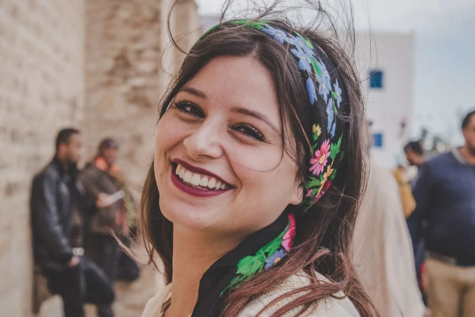 woman with printed head scarf smiling