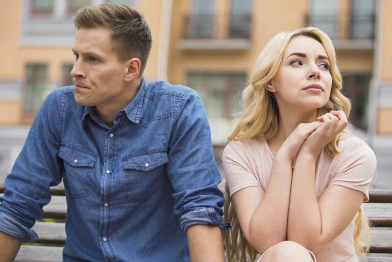 jealous man sitting beside his girlfriend