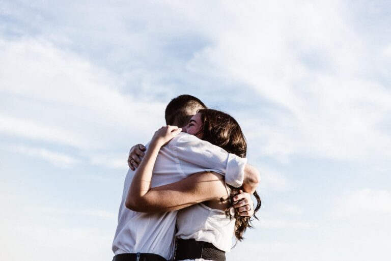 man and woman hugging while standing outdoor