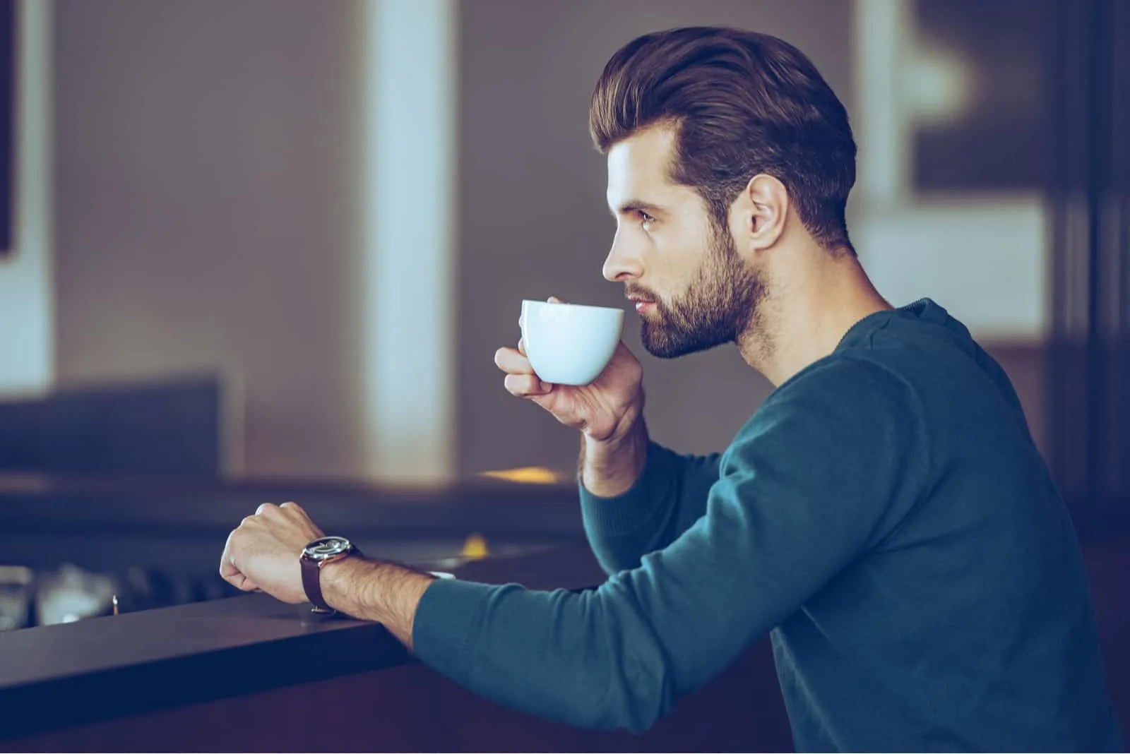 an imaginary man sits and drinks coffee