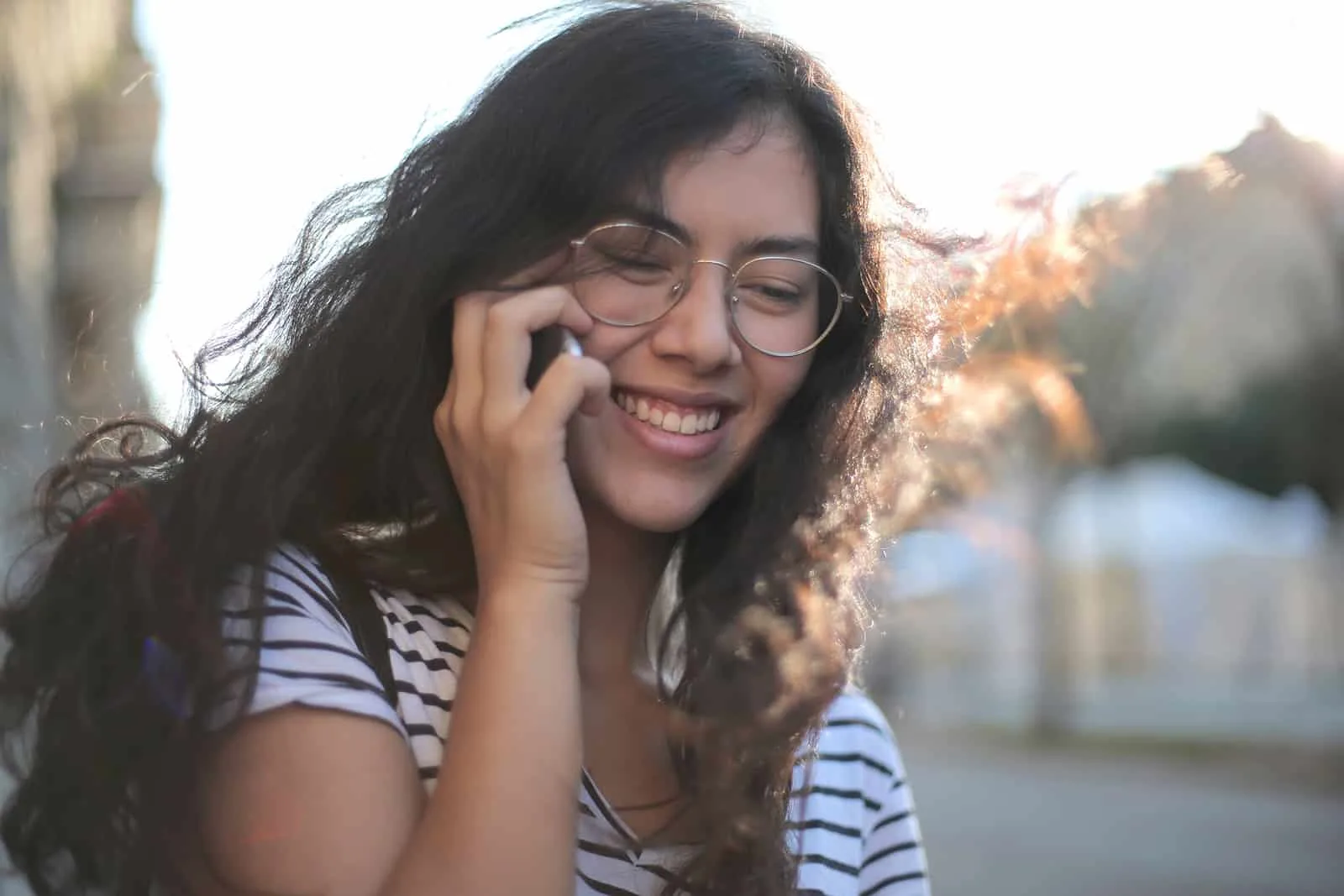 cheerful woman having a phone call on the street