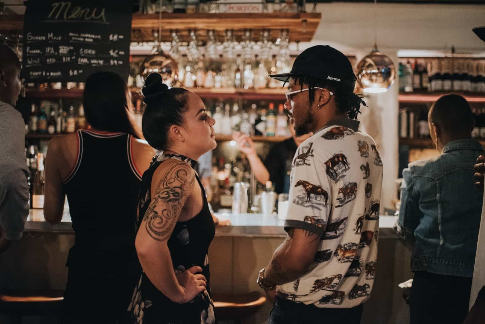 hombre y mujer hablando en un bar