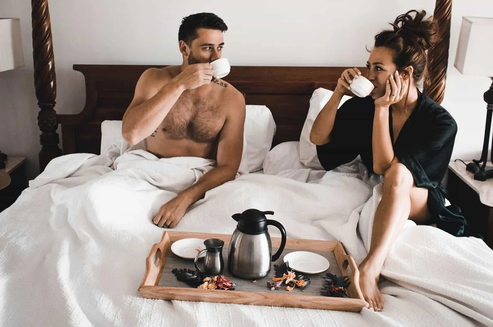 loving couple drinking coffee in a bed in the morning