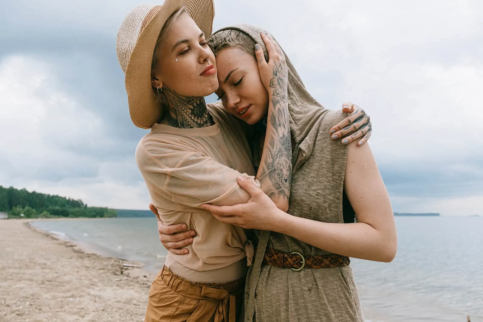 two female friends hugging on the beach