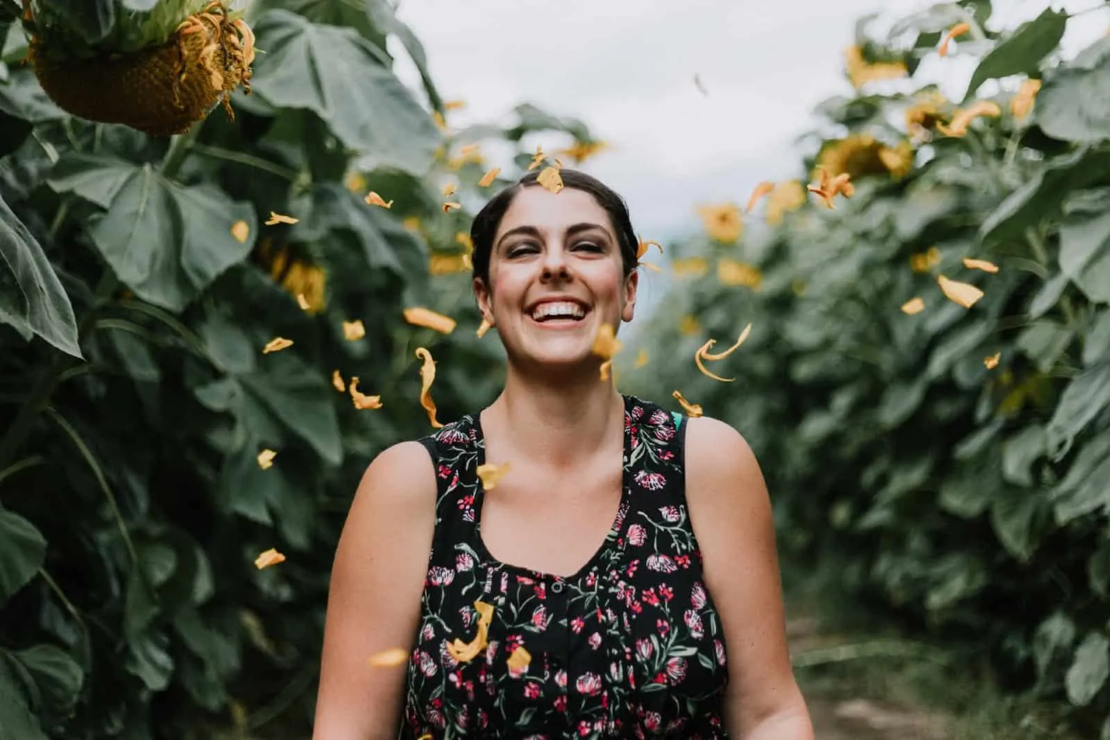 woman smiling while standing in corn field