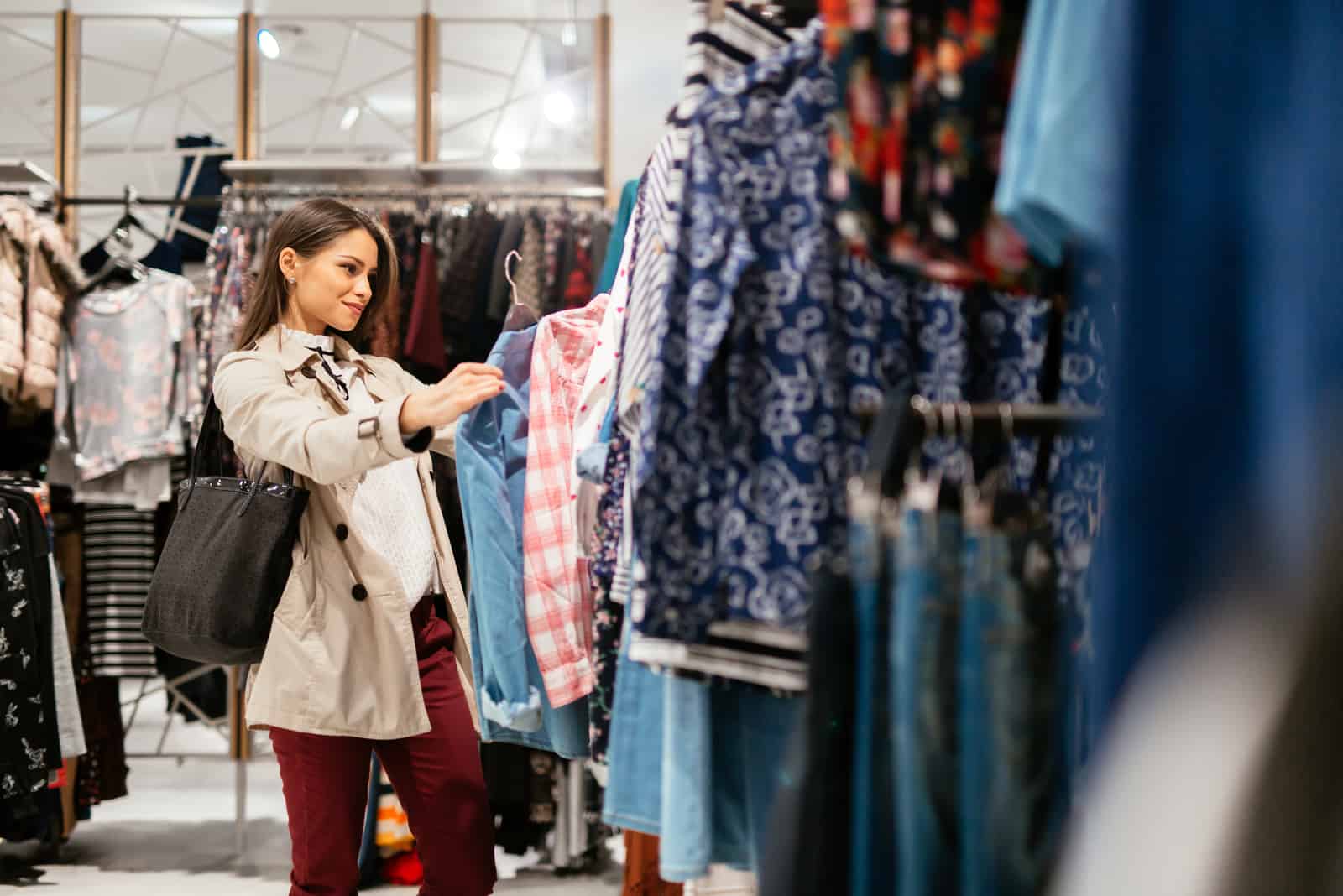 a woman in soping chooses clothes