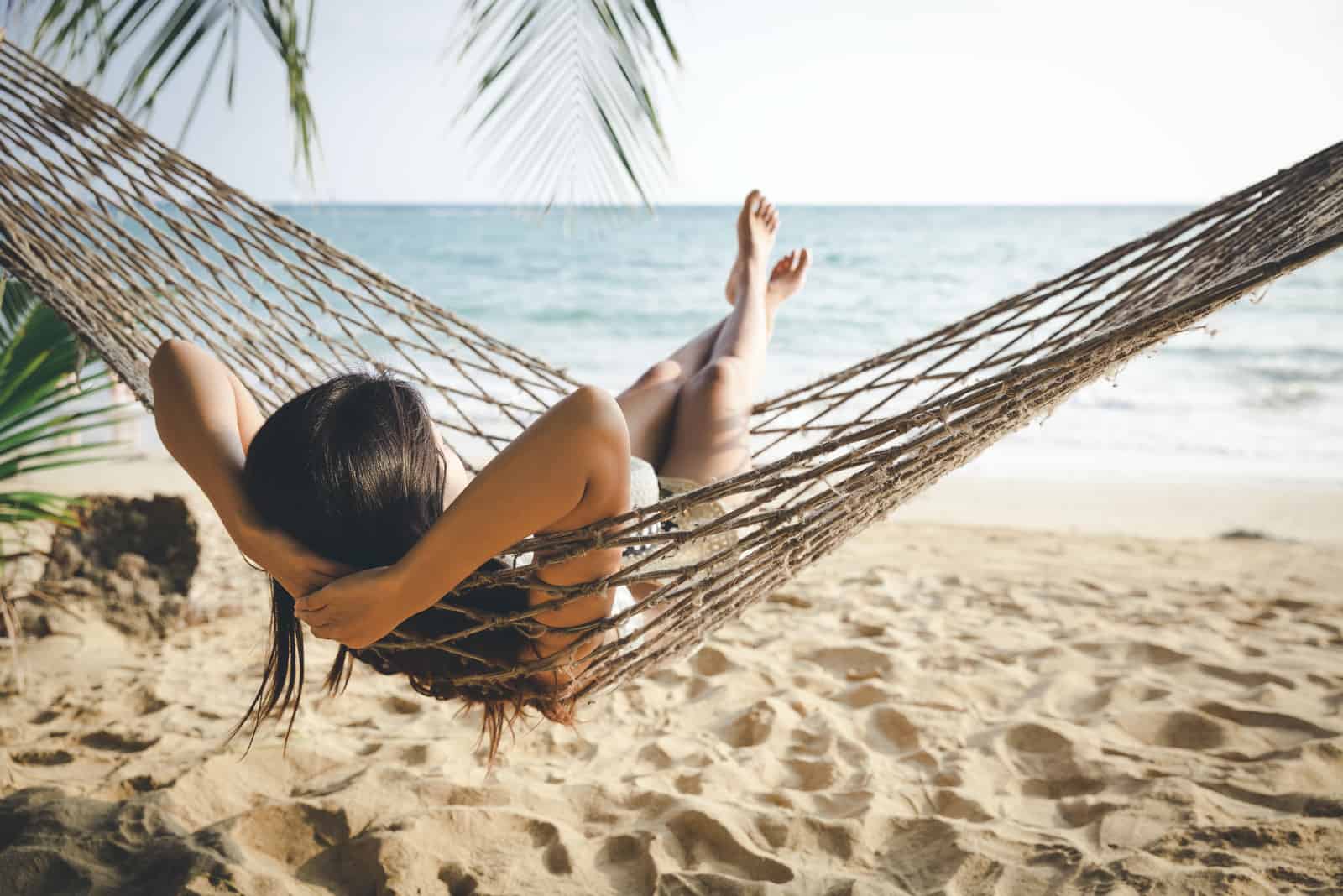 the woman is lying on a deck chair