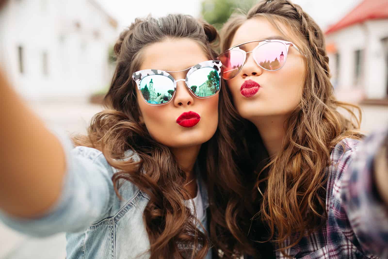 two ladies with red lips and wavy hair