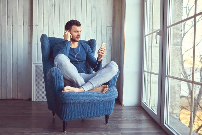 a man sits in an armchair and listens to music