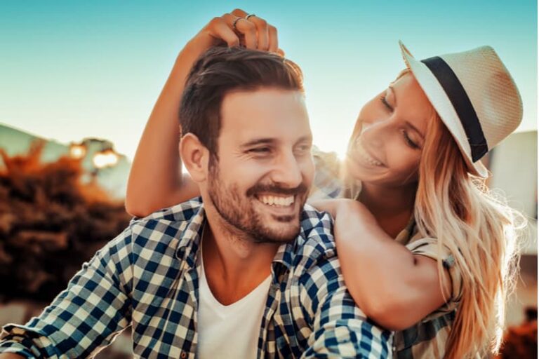 a smiling man and woman embracing