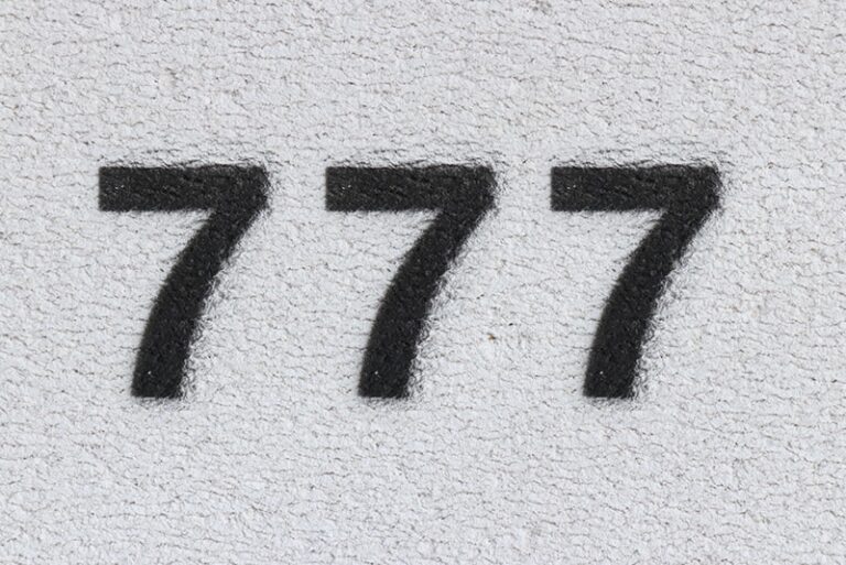 black number 777 on the white wall