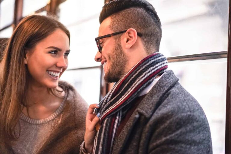 the man and woman laugh and watch