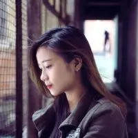 pensive woman standing near the fence