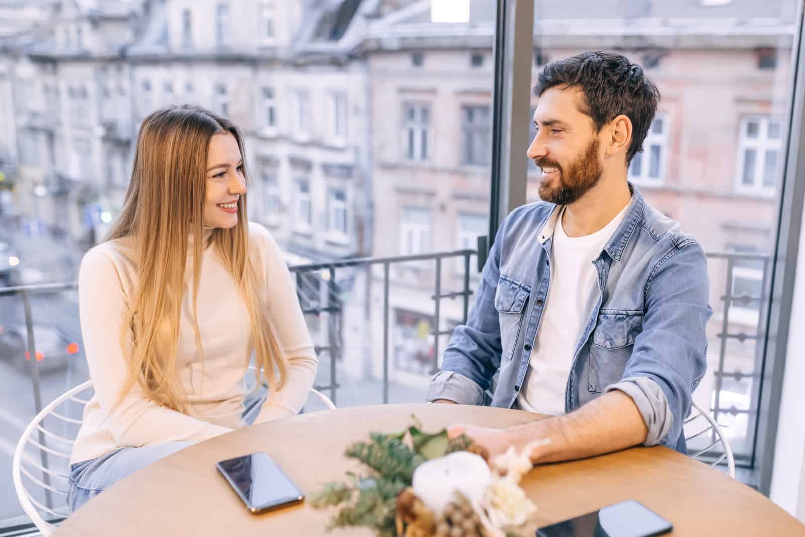 a couple in love sitting in a cafe and talking