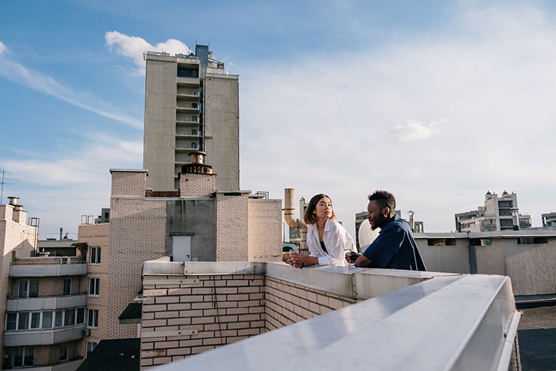 couple drinking wine on the rooftop and talking
