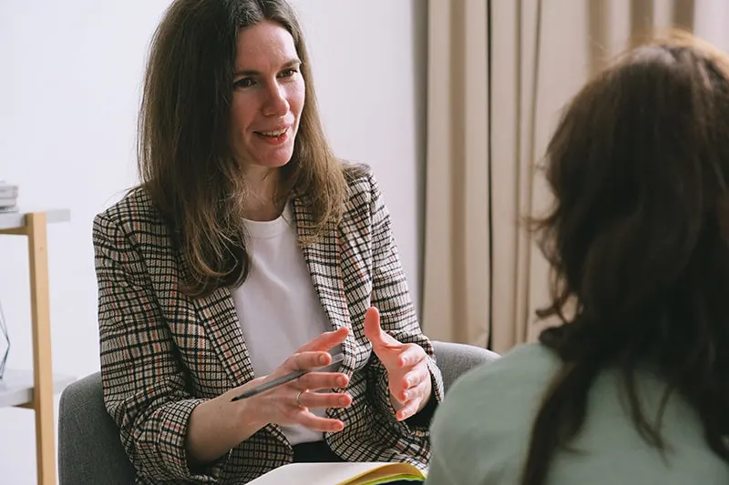 therapist talking with a woman during a session