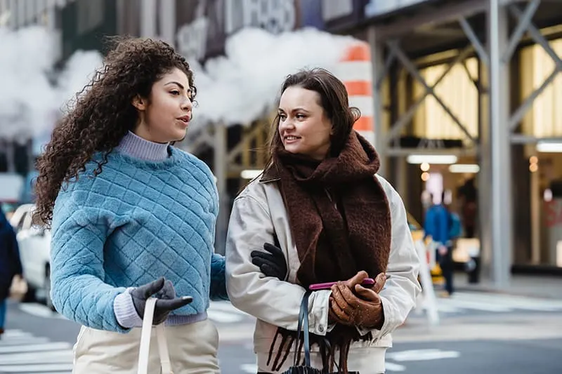 two female friends talking on the street