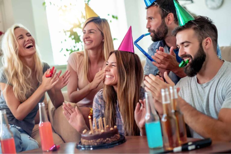 friends sit and celebrate a birthday