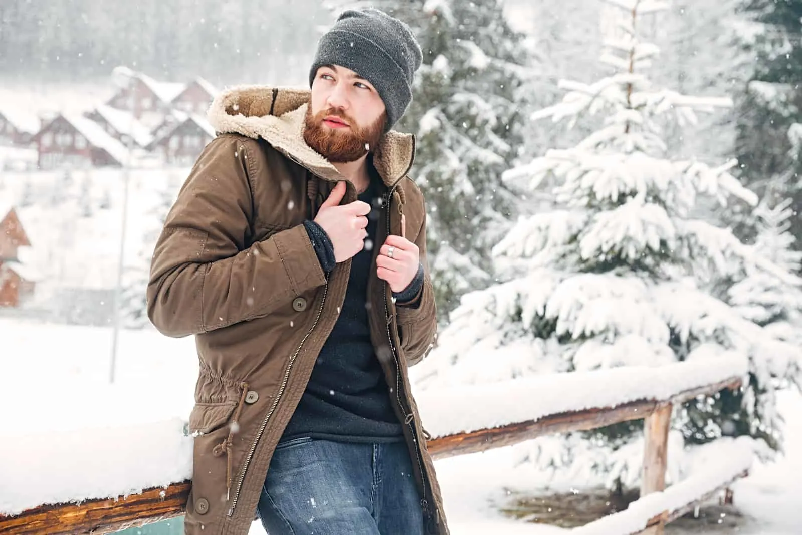 Attractive bearded man standing outdoors in winter