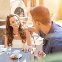 un hombre sentado a la mesa con una mujer y hablando