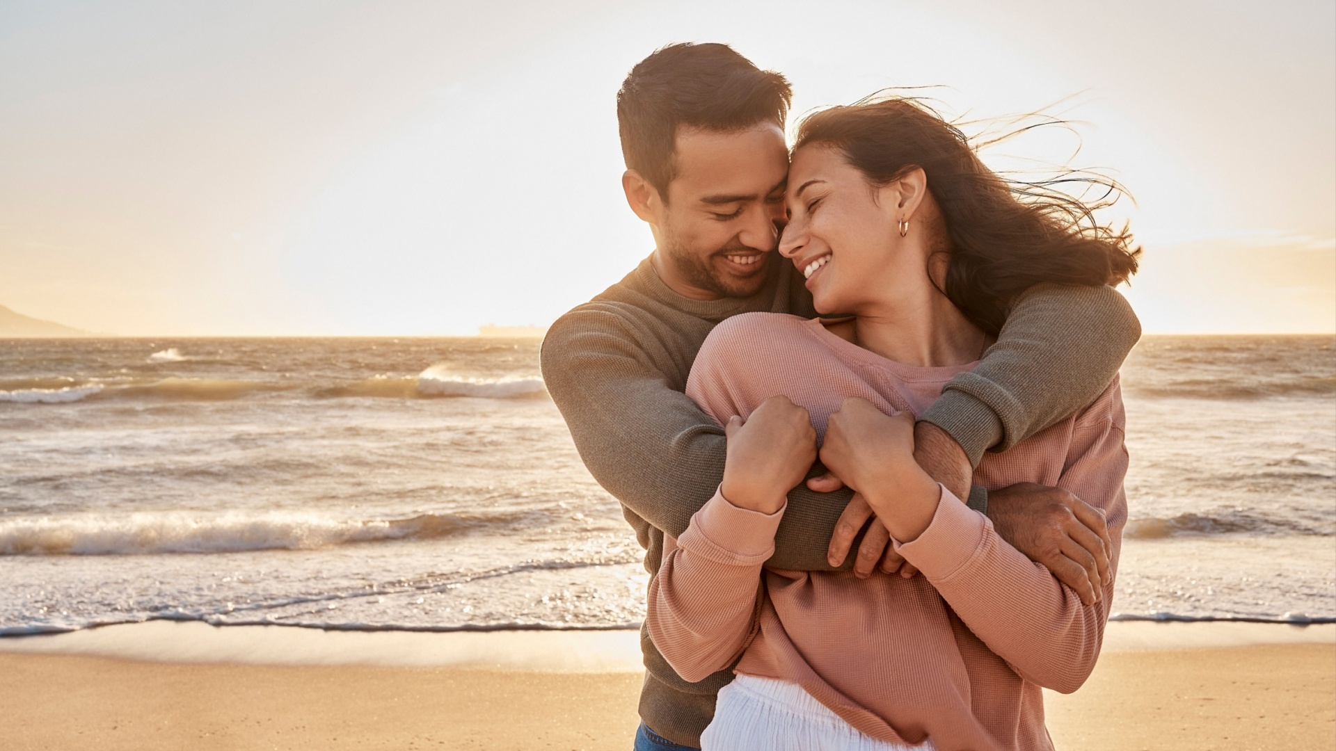 couple hugging at the beach