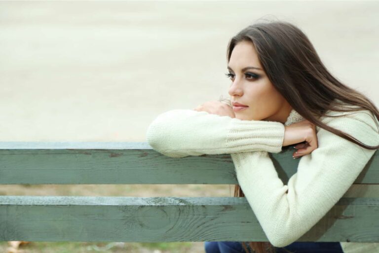the imagined woman sits leaning against the bench