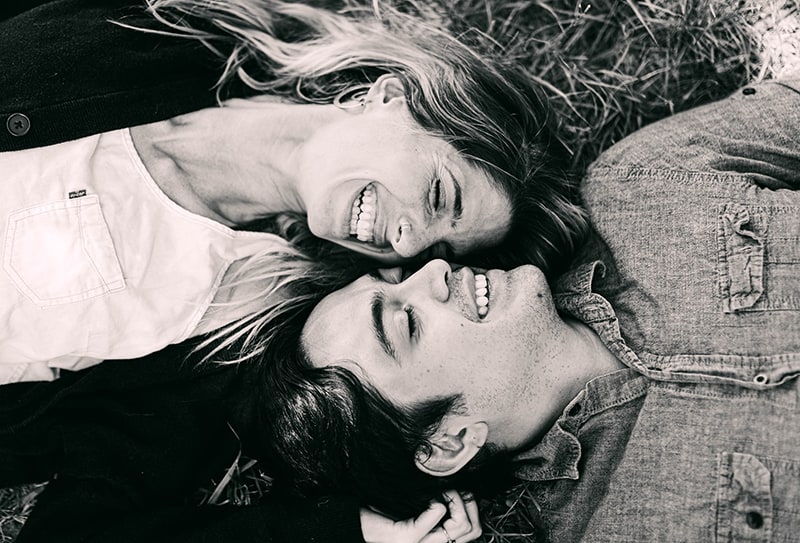 happy smiling couple lying on the ground