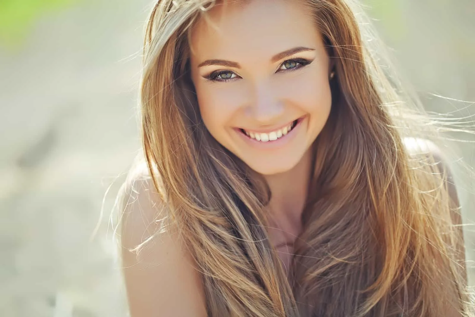 a beautiful smiling woman with long brown hair