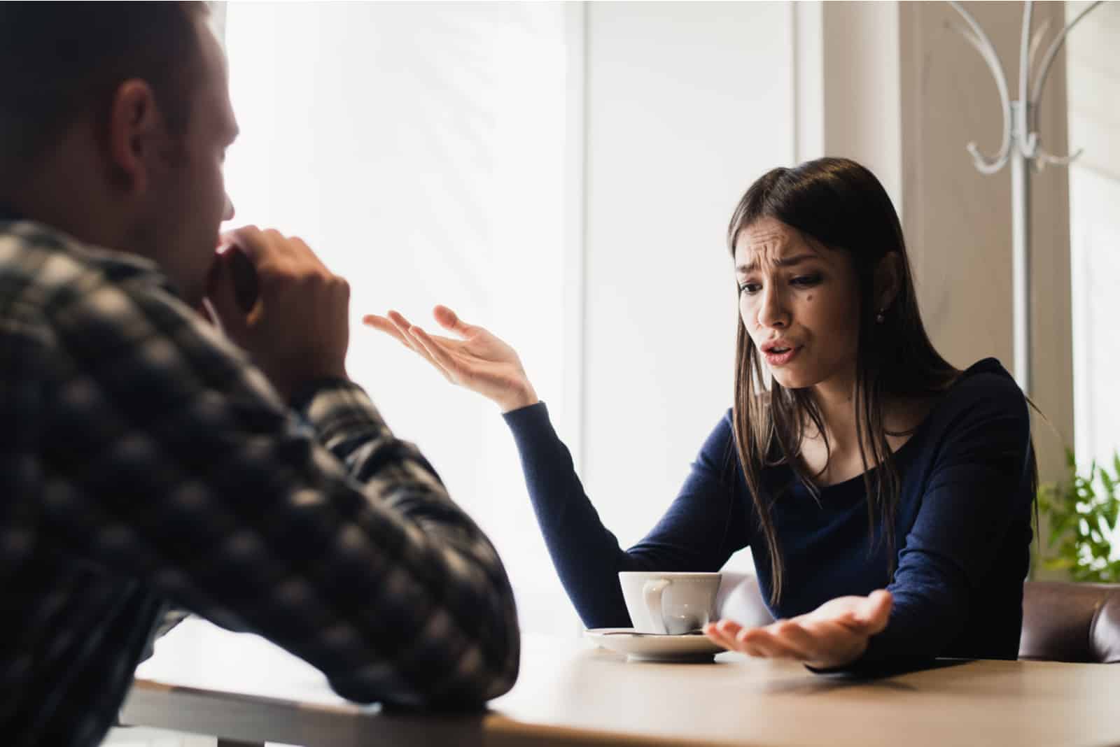 a black-haired woman quarrels with a man