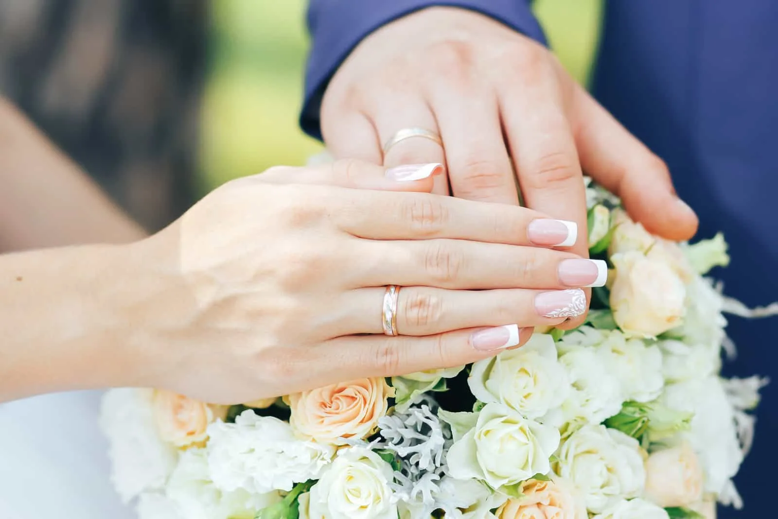 a man and a woman held out their hands with wedding rings