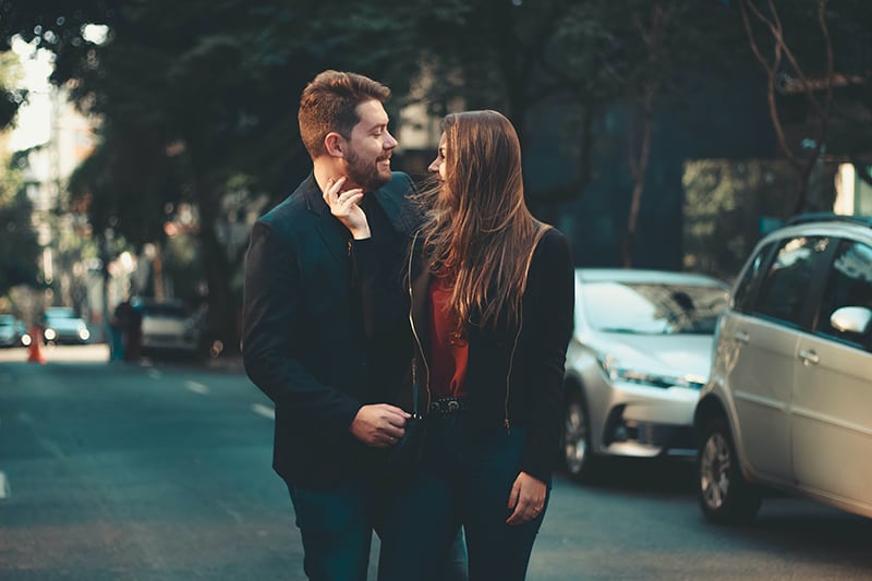 couple walking on the street and cuddling