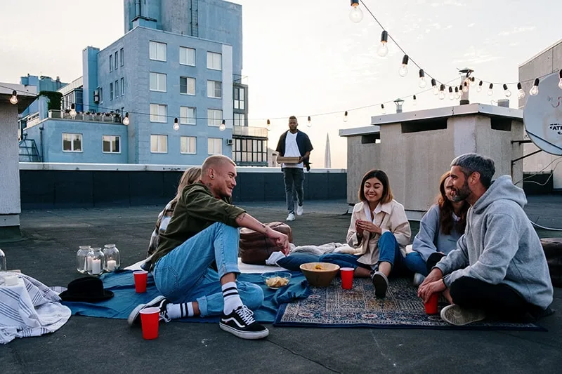 group of friends hanging out on the rooftop of the building