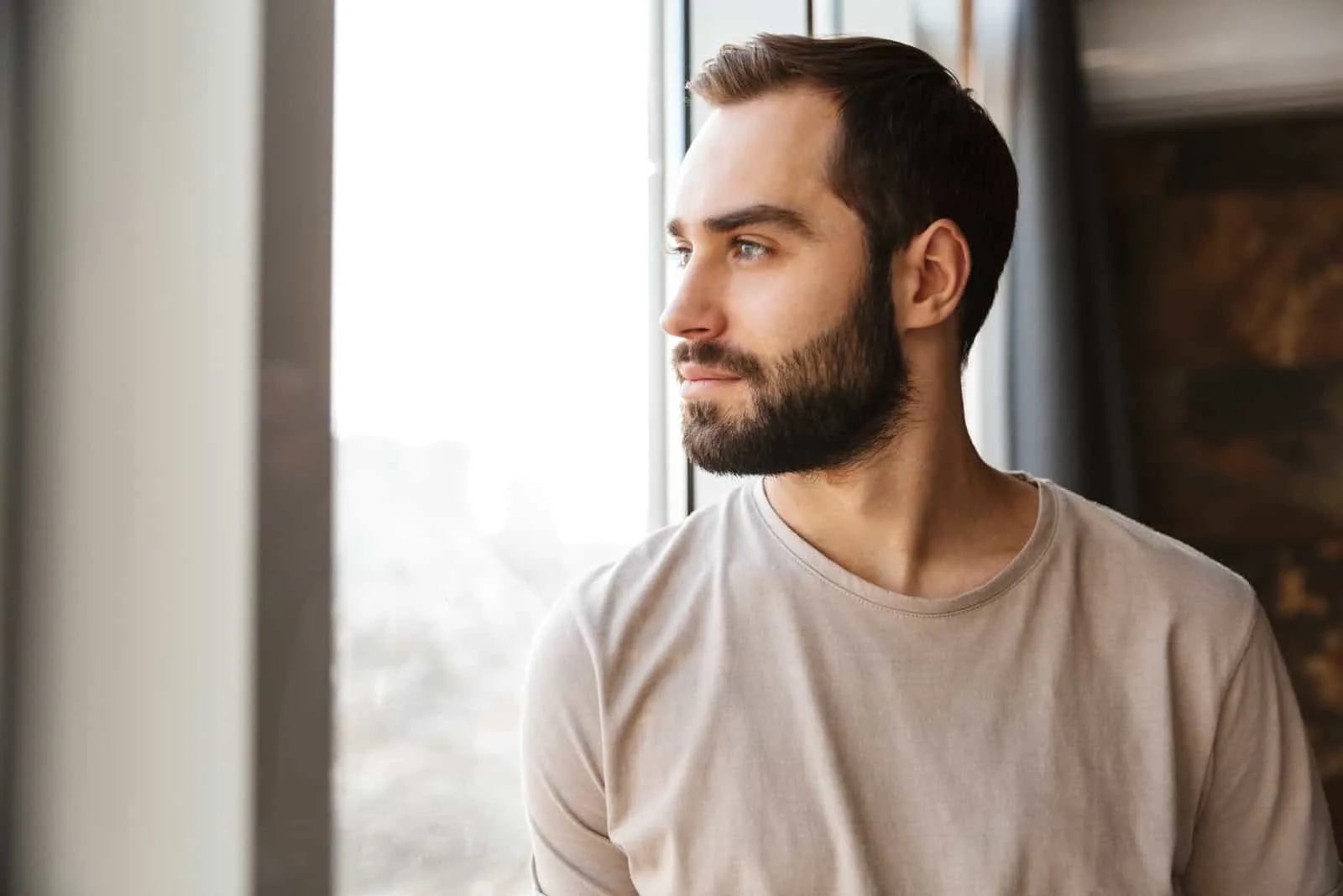 man standing at the window at home
