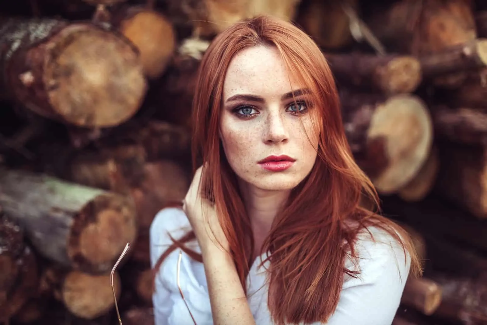 redhead young girl with healthy freckled skin wearing white top