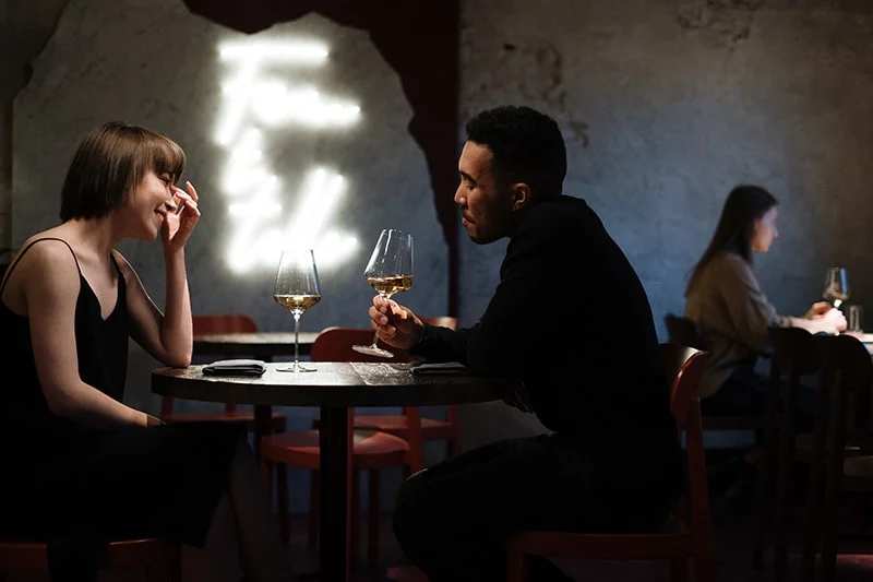 romantic couple drinking wine in restaurant celebrating anniversary