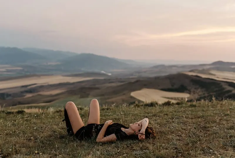 woman lying on the field facing the sky
