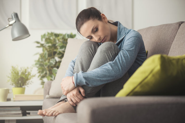 woman curled on couch