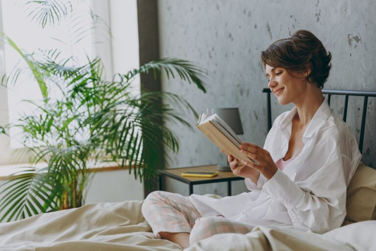 woman reading a book in bed